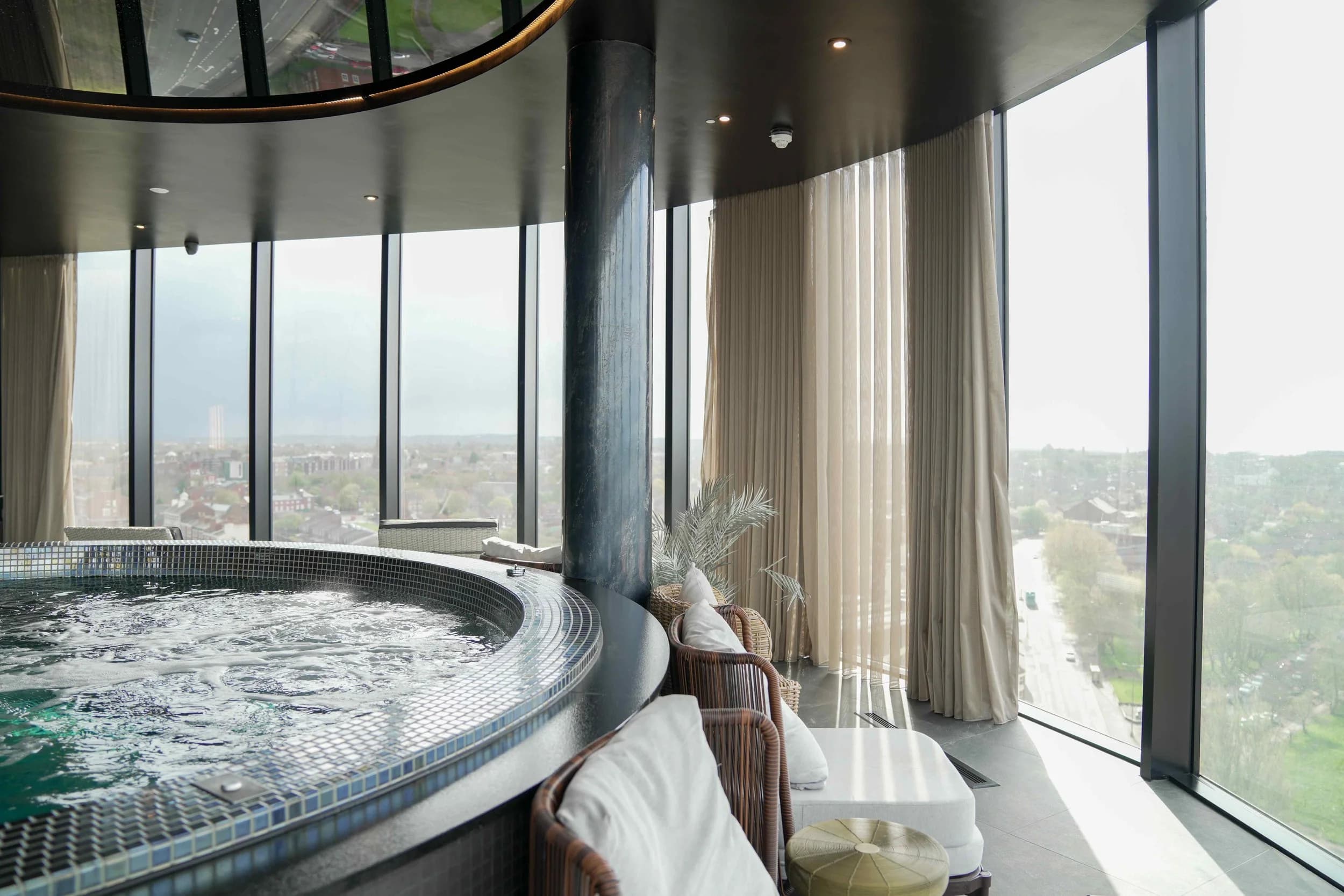 Daytime at the glass-walled rooftop jacuzzi pool, Jayde Spa Liverpool.